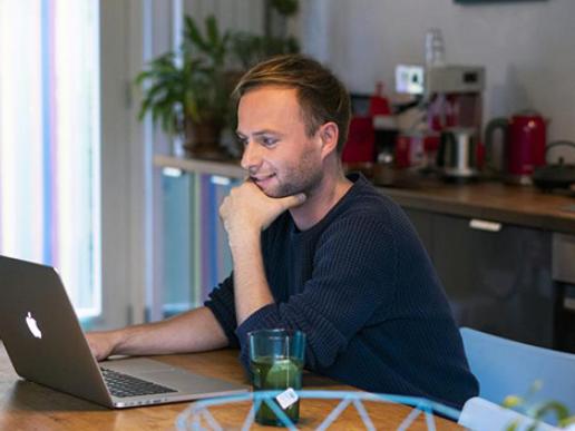 Jongeman achter laptop